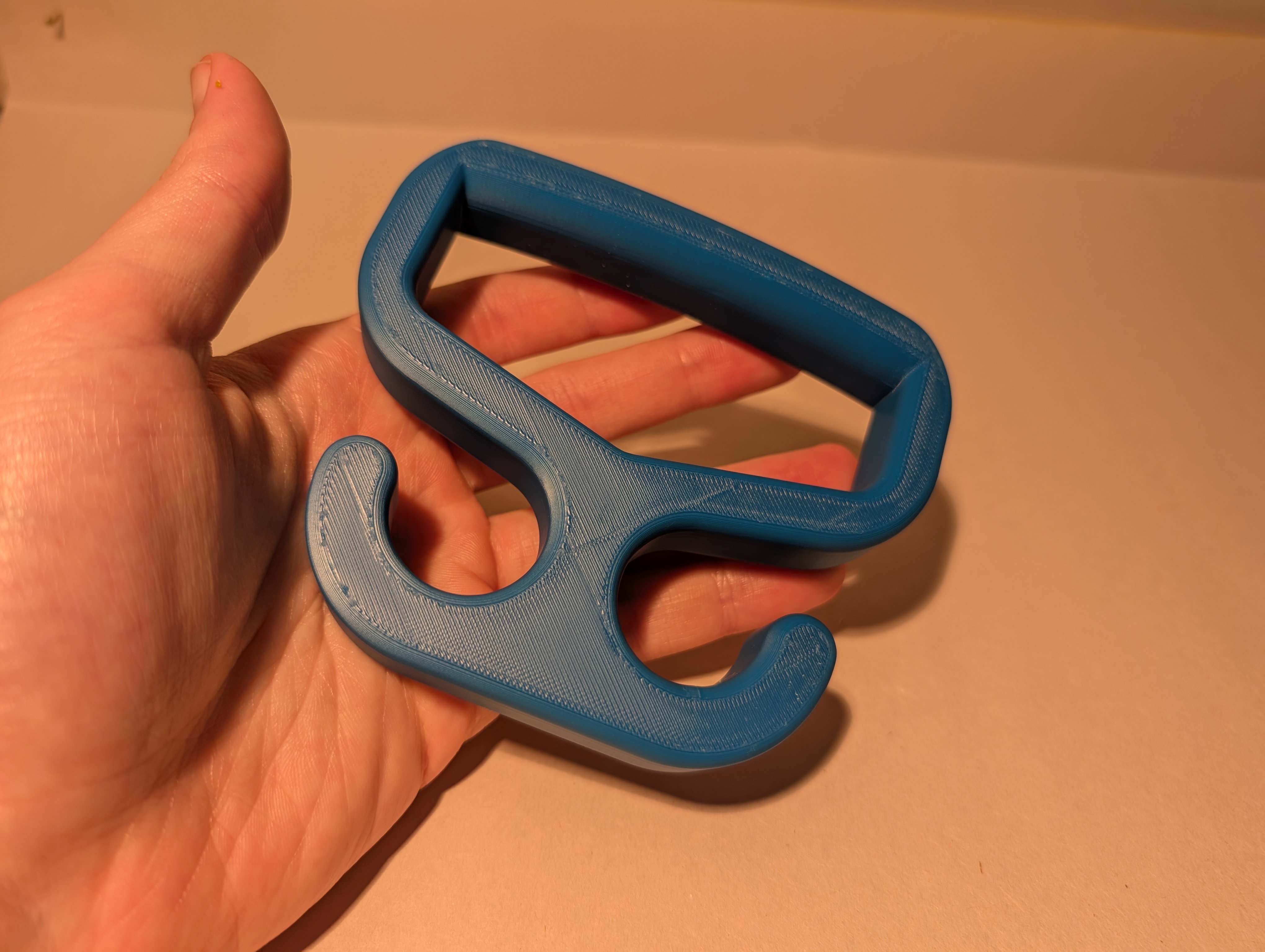 Blue 3D printed Bag Carrier shown in hand