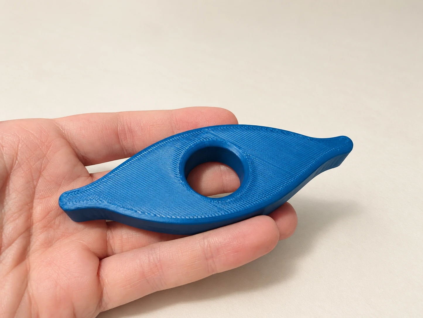 Blue 3D printed Book Holder shown in hand