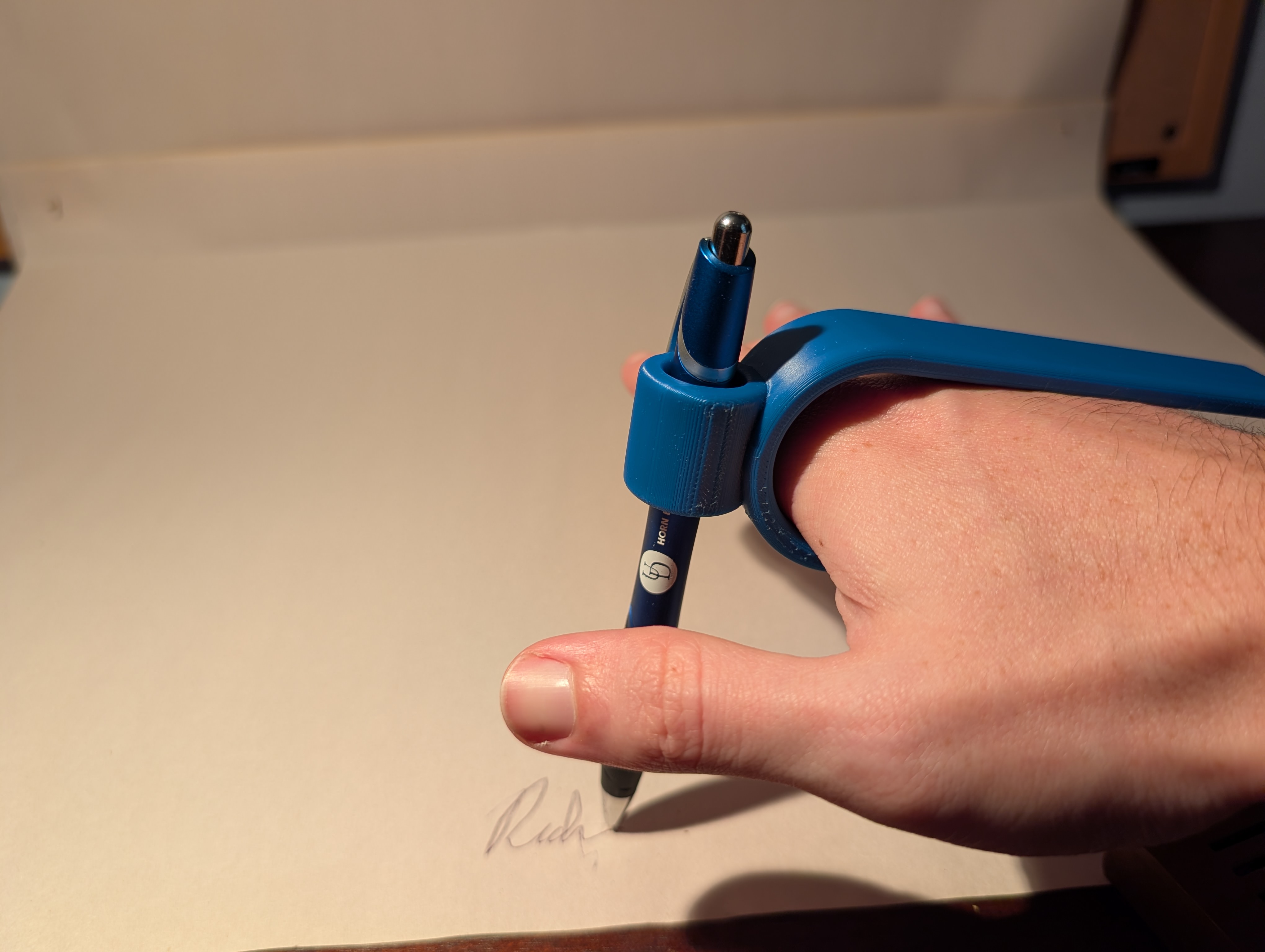 Blue 3D printed Palm Pen shown in hand
