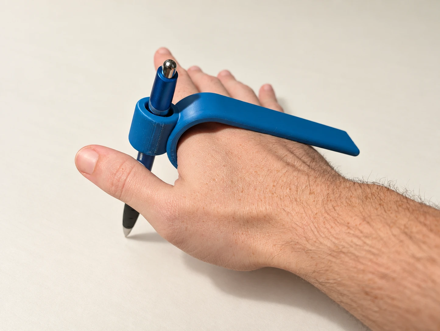 Blue 3D printed Palm Pen shown in hand