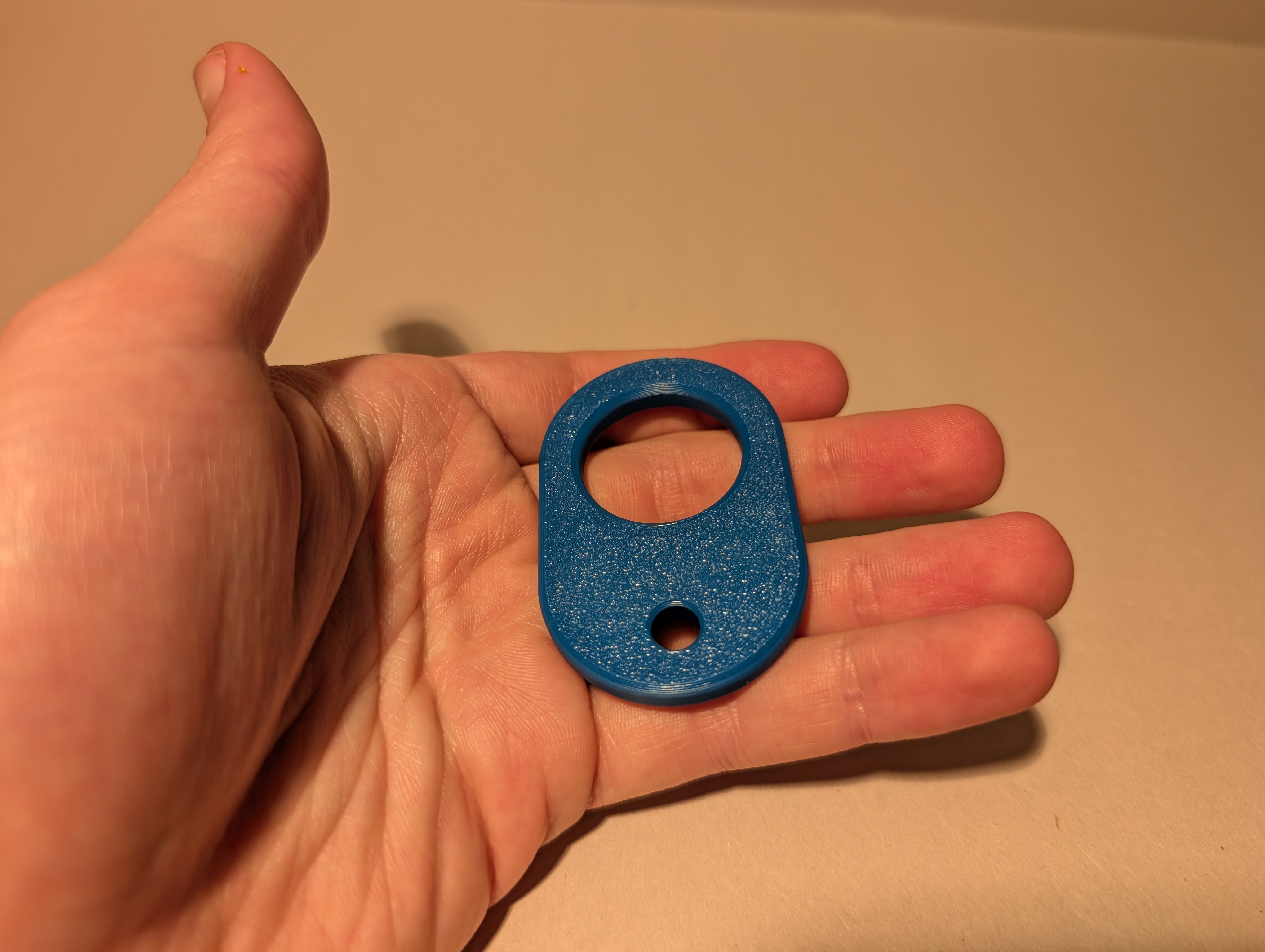 Blue 3D printed Zipper Aid shown in hand