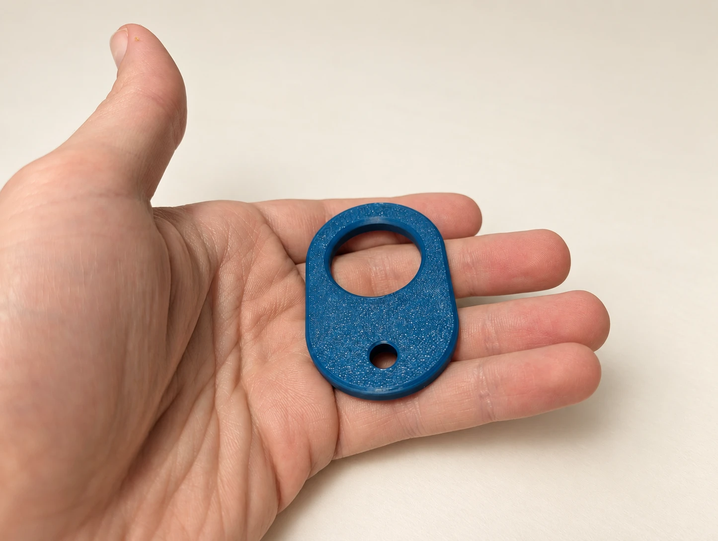 Blue 3D printed Zipper Aid shown in hand